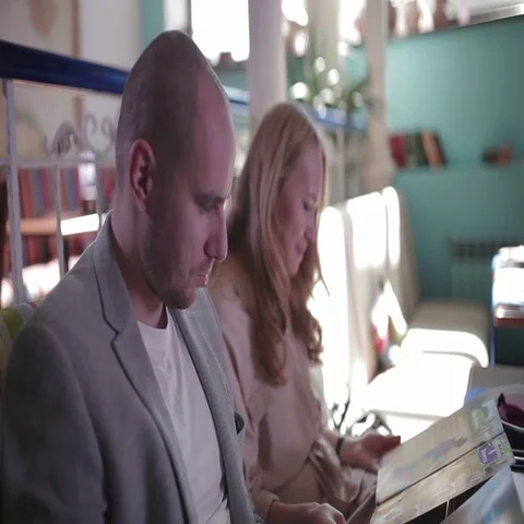 Young couple looking at the menu, choosing dishes Video stock 69281851