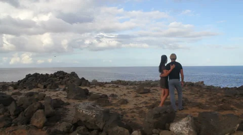 Young couple looking by the ocean Stock Footage 37203700