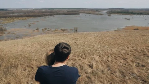 Young couple looking at the river. Spring, autumn, wind. Stock Footage 94873184
