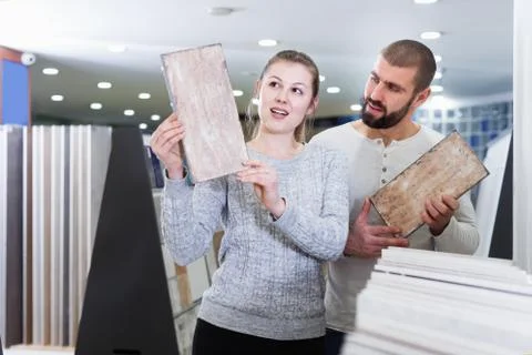 Young couple looking sample of ceramic tile Stock Photos