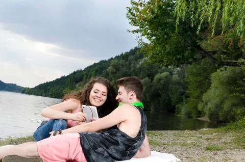 Young couple looking at the screen of mobile device Stock Photos