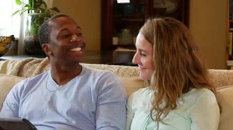 Young couple looking at tablet laugh and smile Stock Footage 53022567
