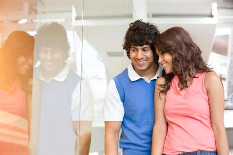 Young couple looking at window display together Stock Photos