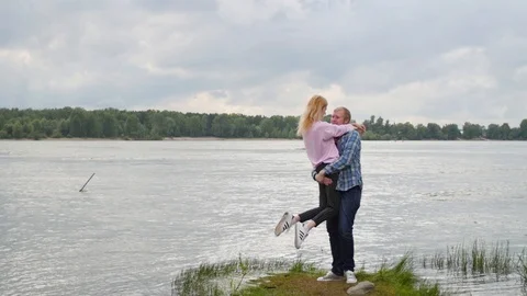 Young couple in love on the background of the river. a woman and a man are Stock Footage 106964780