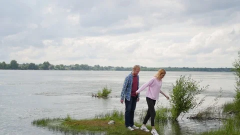 Young couple in love on the background of the river. a woman and a man are 스톡 동영상 106964799