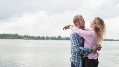 Young couple in love on the background of the river. a woman and a man are Stock Footage 106964959