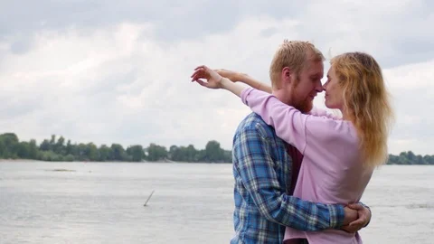 Young couple in love on the background of the river. a woman and a man are 動画素材 107383801