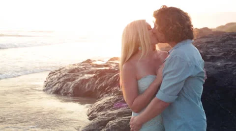 Young Couple in Love on the Beach at Sunset Stock Footage 26681818