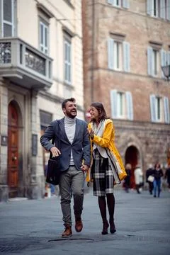 A young couple in love is chatting while enjoying a walk the old city. Walk.. Stock Photos