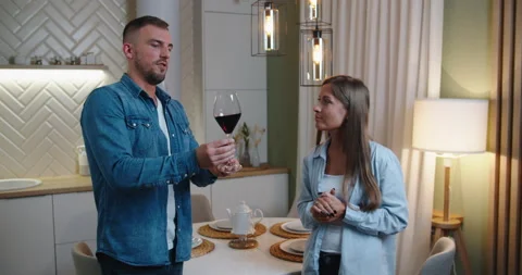 Young couple in love drinking red wine in house kitchen - Happy millenial people Stock Footage 142035962