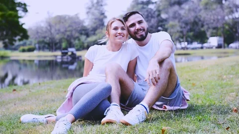 Young couple in love exercise on the grass field. Stock Footage 106770686