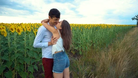 Young couple in love having fun on a date in a field of sunflowers. Stock Footage 112139943