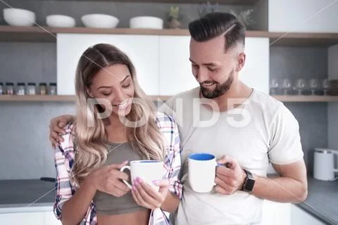 Young couple in love in the kitchen in a good morning Stock Photos