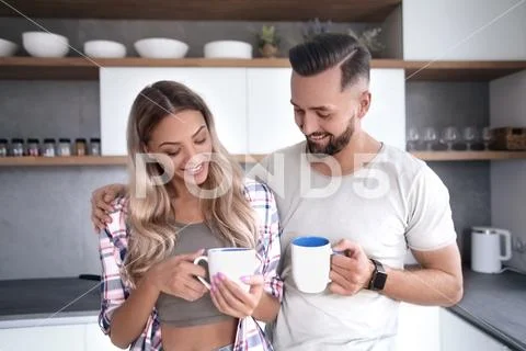 Young couple in love in the kitchen in a good morning Stock Photos