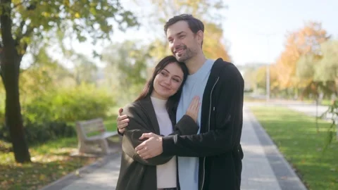 Young Couple in Love Posing Together in a Park on a Cozy Fall Day Stock Footage 303989332