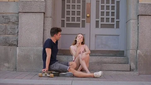 Young couple in love sit on threshold steps on Nevsky prospect and talk in slo Stock Footage 75706245