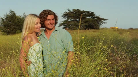 Young Couple in Love Standing in Grass Field Stock Footage 26679569
