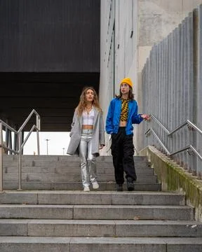 Young couple in love talking while taking a walk through the city. Stock Photos