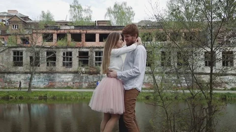 Young couple in love walking in summer park holding hands. Woman in pink tutu Stock Footage 75902453