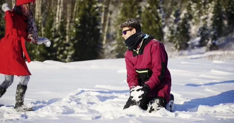 Young couple of lovers have fun playing snowballs in mountain park. Happy people Stock Footage 145011310