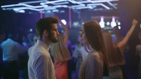 Young couple of lovers looking at each other in neon light of night club. Romant Stock Footage 199485126