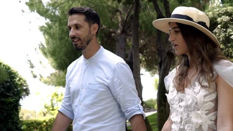 Young couple of lovers walking by handle in park. Action. Lovely couple talking Vidéo 115039351