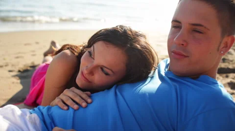Young couple lying on beach Stock Footage 43618118