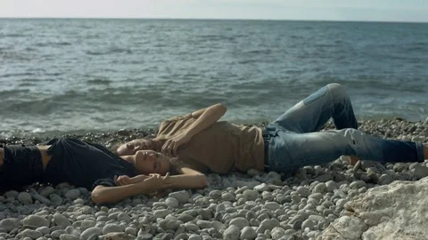 Young couple lying on the beach Stock Footage 72153302