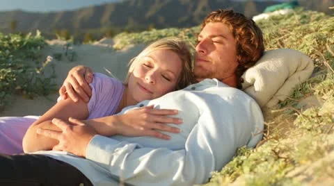 Young Couple Lying on Beach Mountain Backdrop Stock Footage 21836094