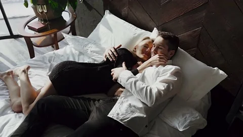Young couple lying in bed. Video stock 143579786