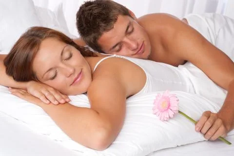 Young couple lying in bed Stock-Fotos