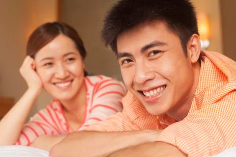 Young Couple Lying on Bed Foto stock