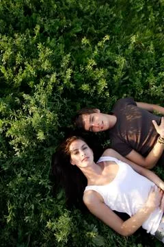 Young couple lying in field Stock Photos