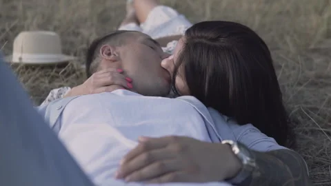 Young couple lying on the grass in the park and kissing 動画素材 145986171