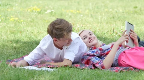 Young Couple Lying on a Grass Reading Students Girl and Boy Are Preparing to 動画素材 64812918