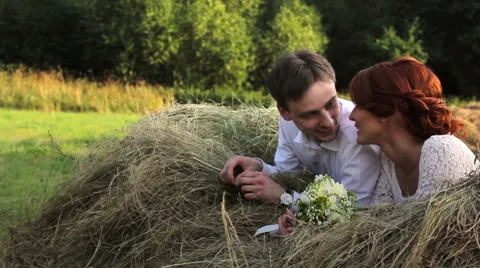 Young couple lying on a haystack Stockbeeldmateriaal 55159922