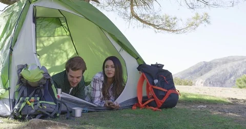 Young couple lying in tent Stock Footage