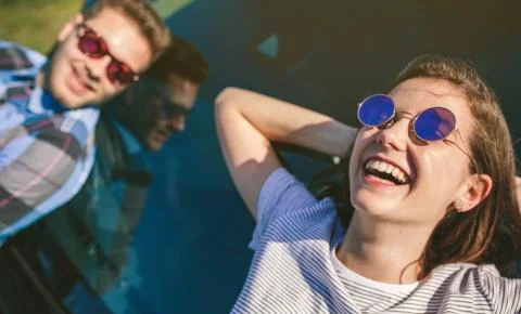 Young couple lying on the windshield Stock Photos