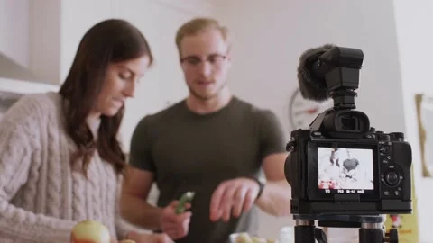Young couple making apple pie and vlogging Stock Footage 220464718