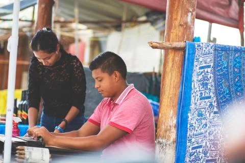 Young couple making cigars. Stock Photos