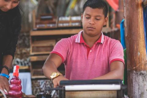Young couple making cigars. Stock Photos