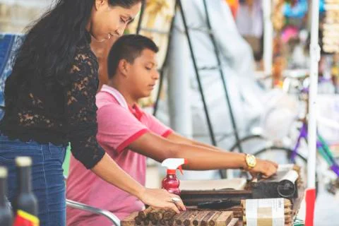 Young couple making cigars. Stock Photos