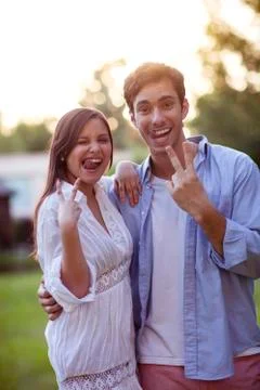 Young couple making faces and finger gestures Stock Photos