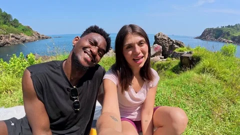 Young couple making funny faces and gestures by the sea Stock Footage 311754310