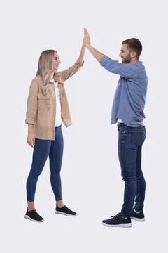 Young Couple Making High Five Standing Isolated. Sign Stock Photos