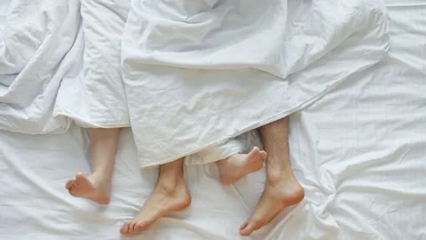 Young couple making love after waking up lying on soft bed Stock Footage 167367288