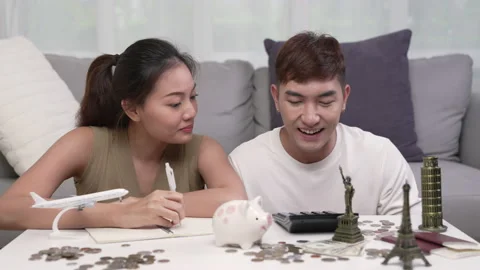Young couple making savings plan for travel and vacation. Stock Footage 218576389