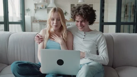 Young Couple making Video-Call at new modern Loft Interieur. Young Family speaks Video stock 157876935