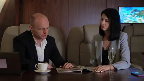 A young Couple a Man Drinking Coffee a Woman Sitting Making a New Business Plan Vidéo 135596308