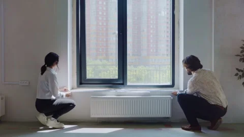 Young Couple Measures Windows in New Apartment Stock Footage 311824324